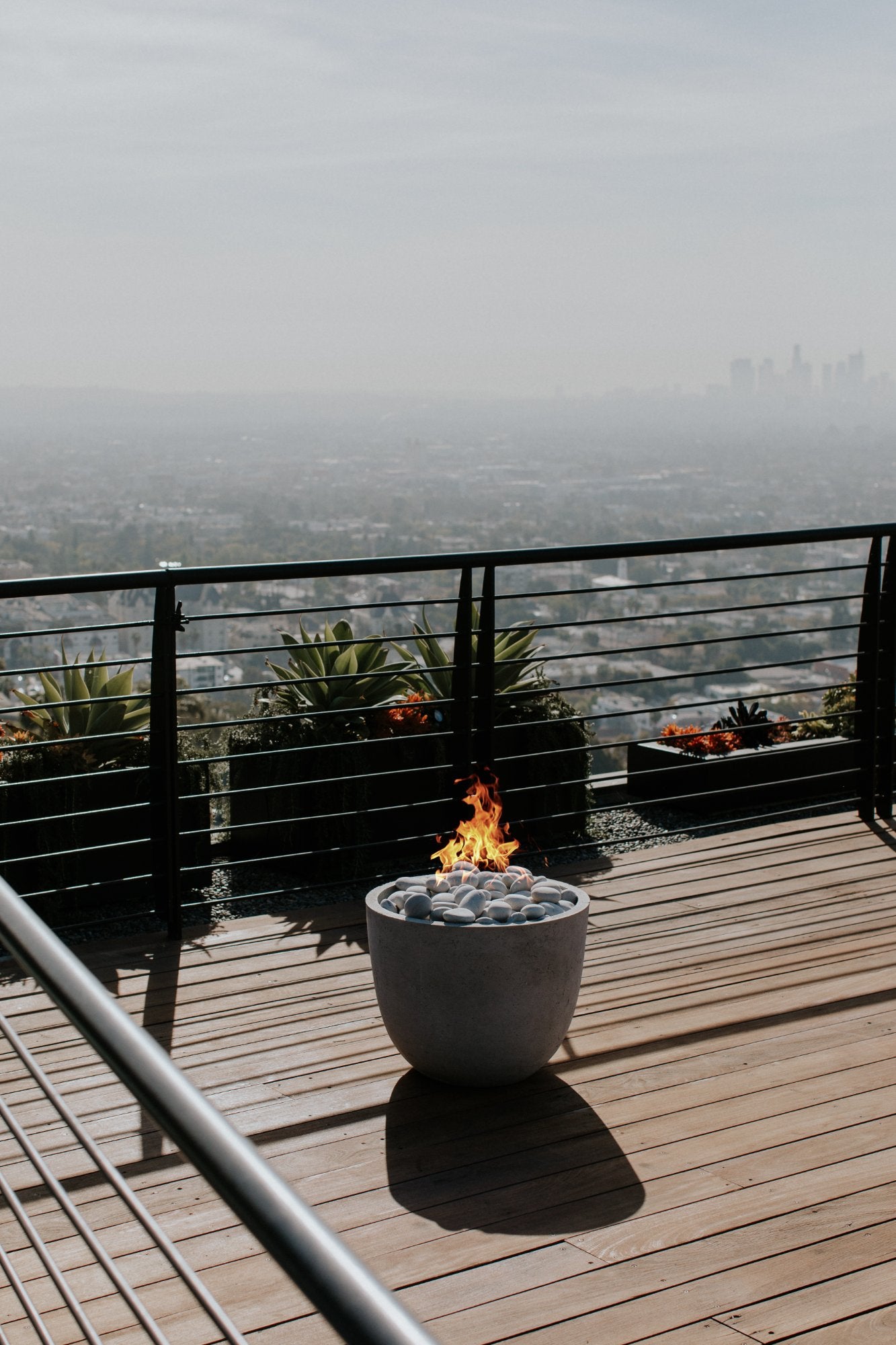 HPC Dekko Element poured concrete fire table in outdoor setting