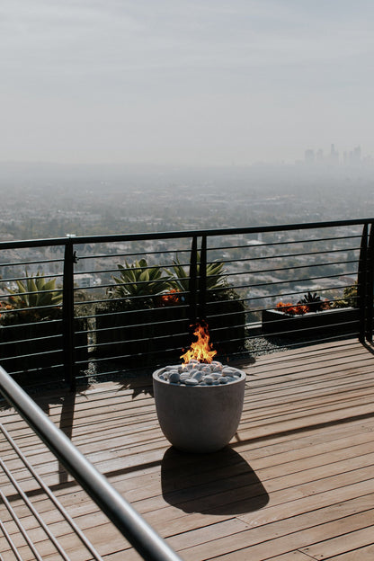HPC Dekko Element poured concrete fire table in outdoor setting