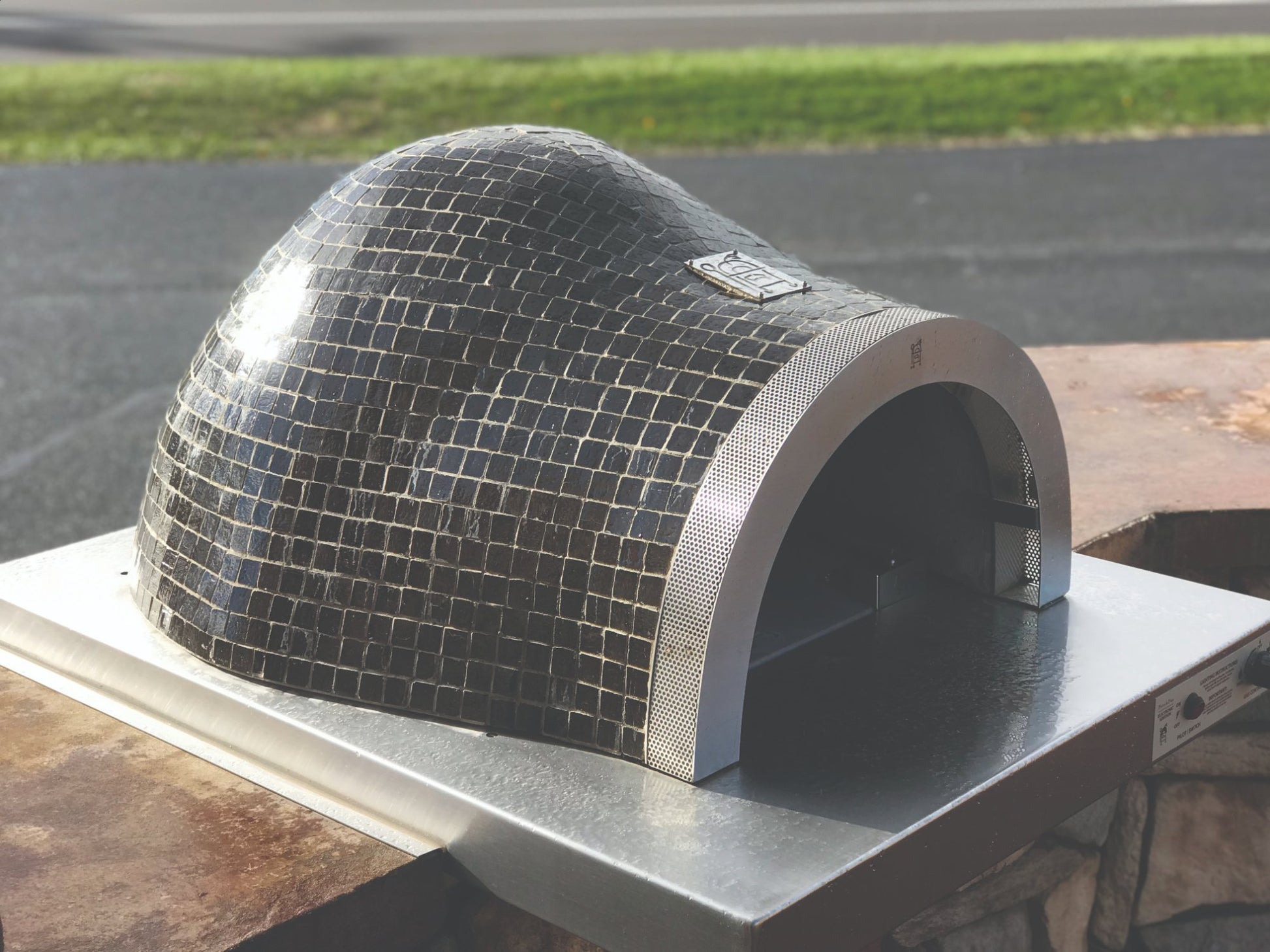 HPC Forno Villa Series dome pizza oven with mosaic tile design outdoors